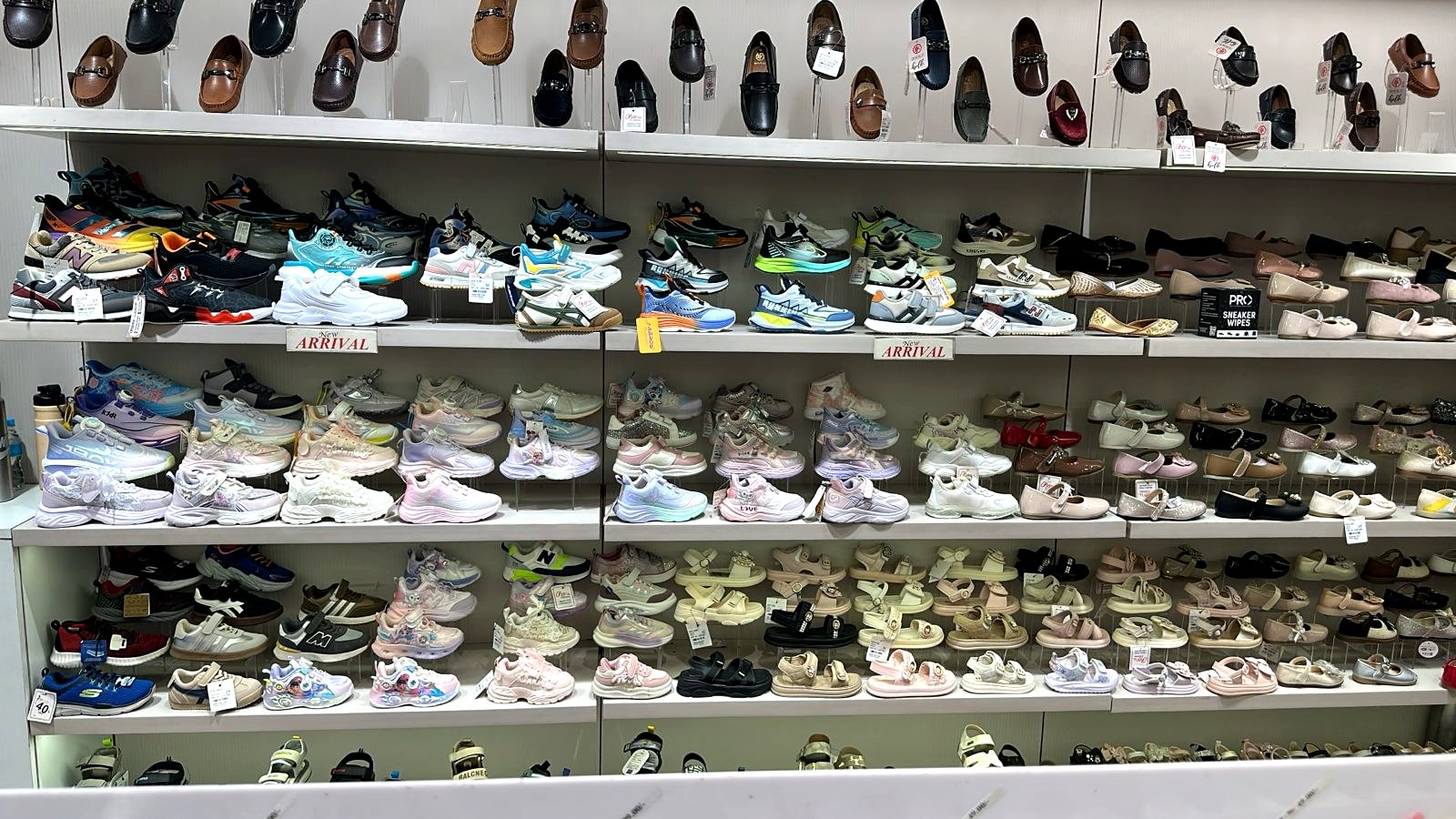 Charu Shoes store interior showing multi-brand shoe shelving with new arrivals